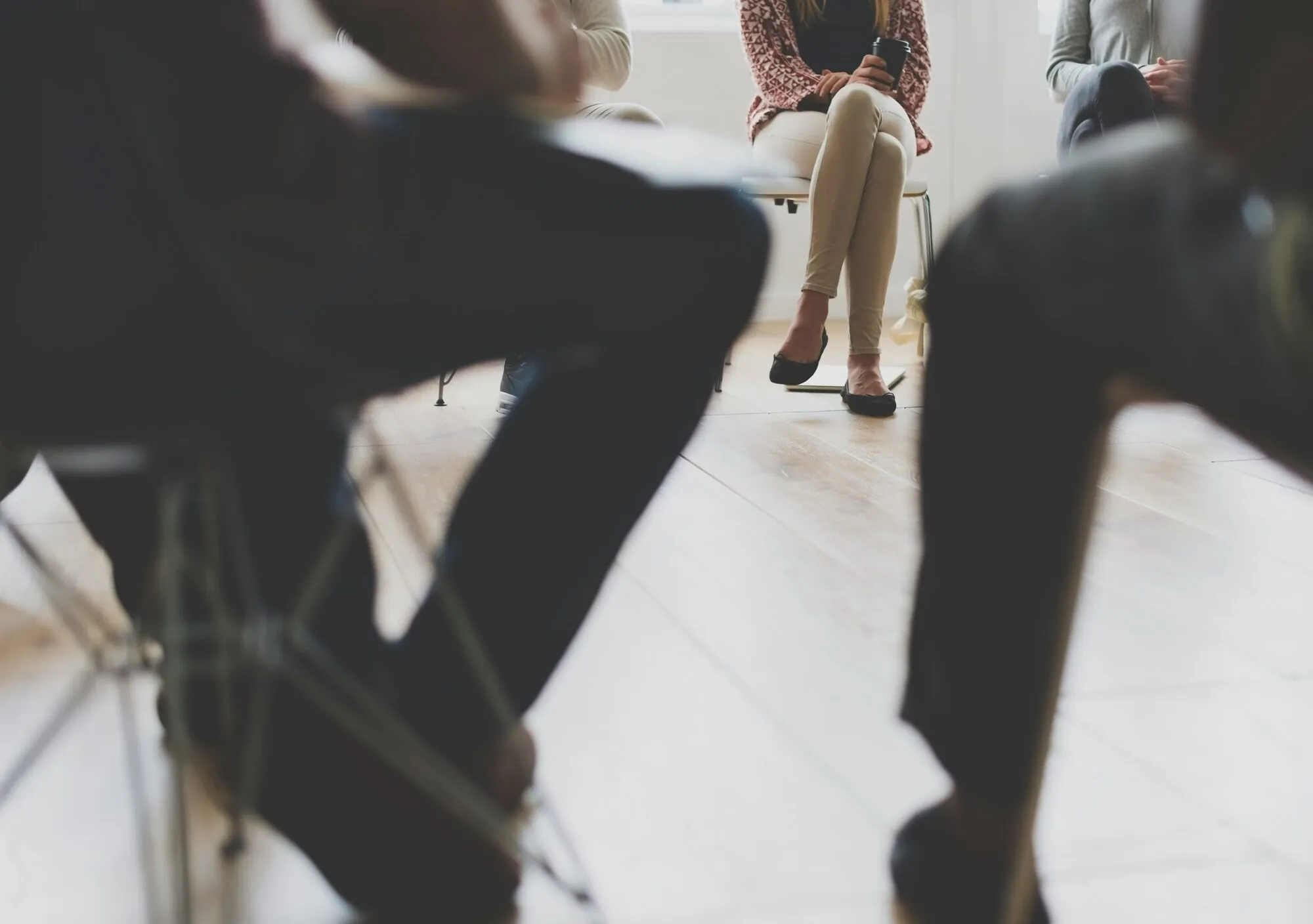 Een kleine groep mensen in overleg, zittend in een kring